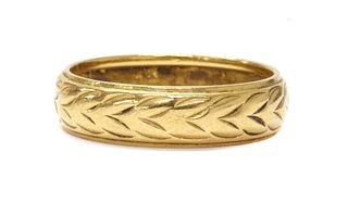 A 22ct gold engraved wedding ring,
