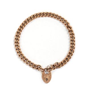 An Edwardian 9ct gold curb link bracelet, by Saunders & Shepherd,