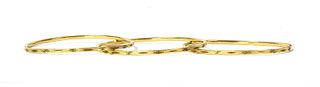 A set of three Indian high carat gold bangles,