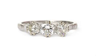 A platinum three stone diamond ring,