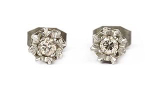 A pair of 9ct white gold single stone diamond stud earrings,