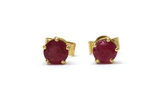 A pair of 18ct gold single stone ruby stud earrings,