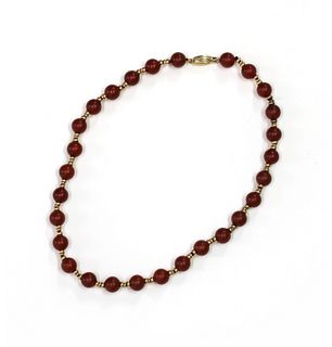 A gold and cornelian bead necklace,