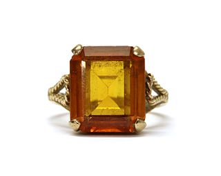 A gold single stone synthetic orange sapphire ring,