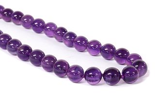 A single row uniform amethyst bead necklace,