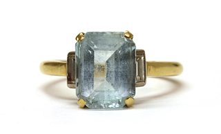 A gold blue topaz and diamond three stone ring,