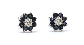 A pair of white gold diamond and sapphire cluster earrings,