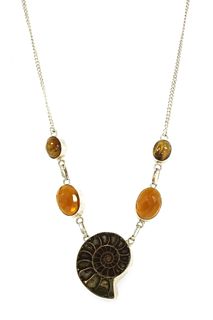 A silver ammonite, glass and tiger's eye necklace,