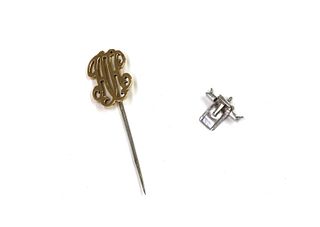 A gold monogram stick pin,