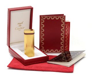 A cased Must de Cartier gold plated gas lighter, c.1990,