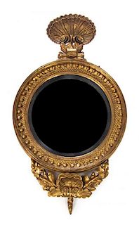 * A Regency Giltwood Bull's Eye Mirror, Height 44 x width 25 1/2 inches.