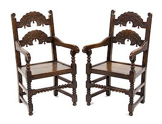 A Pair of Jacobean Revival Carved Oak Open Armchairs, Height 41 inches.