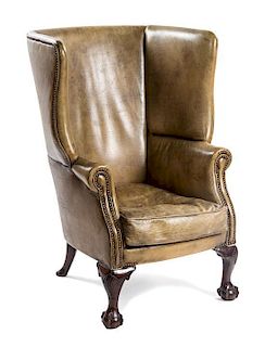 * A Chippendale Style Leather Wingback Armchair, POSSIBLY IRISH, EARLY 20TH CENTURY, Height 44 inches.