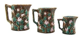 A Set of Three Majolica Pitchers, Height of tallest 5 3/8 inches.