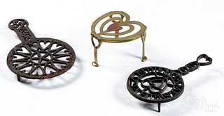 Three iron and brass trivets