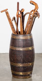 Collection of carved canes and brass bound barrel