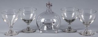 Four colorless glass goblets and a flycatcher