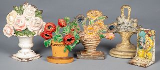 Four cast iron floral doorstops, early 20th c.