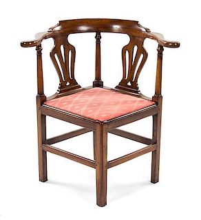 * A George III Walnut Corner Chair, 19TH CENTURY, Height 31 3/4 inches.