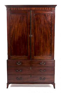 * A George III Mahogany Linen Press, EARLY 19TH CENTURY, Height 84 x width 49 x depth 24 1/4 inches.
