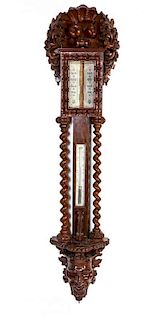 An English Carved Walnut Barometer and Thermometer, Height 49 inches.