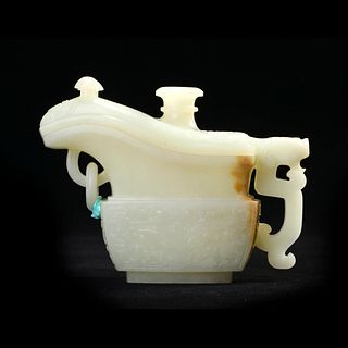 A WHITE JADE ARCHAISTIC 'DRAGONS' JADE VESSEL