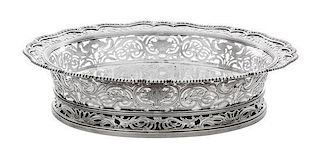 * An English Silver Center Bowl, Paul Crespin, London, 1744, of oval, reticulated form with a gadrooned rim over the pierced fol