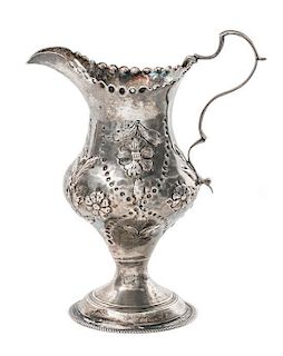 A George III Silver Creamer, George Gray, London, 1783, having hammered floral and foliate decoration.