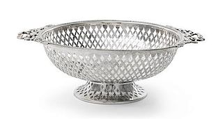 * An Edwardian Silver Small Basket, Goldsmiths & Silversmiths Co. Ltd., London, 1908, circular, with pierced sides and applied r