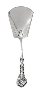 A George V Silver Scoop, Omar Ramsden, London, 1923, having a trapezoidal bowl and a pine cone decorated handle.