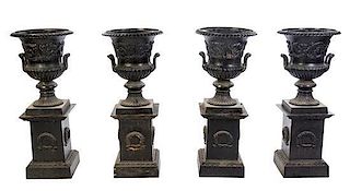 A Set of Four Victorian Style Cast Iron Urns on Stands, Height overall 42 1/2 inches.