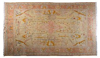 * An Oushak Wool Carpet, CIRCA 1900, Length 12 feet 8 inches x width 10 feet 3 inches.