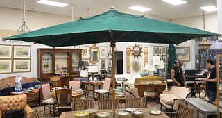 Country Casual Teak Outdoor Umbrella, top measuring 7' x 11', price when new $2,000, two small holes to top.