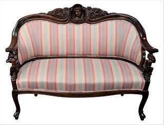 Victorian Loveseat having putti arm supports, height 40 inches, width 52 1/2 inches.