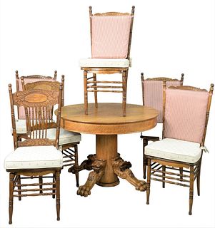 Seven Piece Victorian Oak Dining Set, with six pressed back chairs and round oak pedestal table with lions and large paw feet, height 29 1/2 inches, d