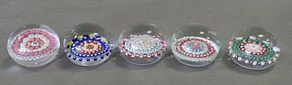 Five Baccarat Millefiori Glass Paperweights, each having five rows of flowers, each marked to the underside, height 2 inches, diameter 2 1/2 inches. P