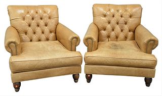 Pair of Leather Armchairs, having tufted backs and brass tack details on the arms (soiled), height 33 inches, width 33 inches, depth 32 inches.