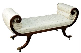 Regency Style Bench, having rolled arms on downswept members ending in brass paw feet and castors, height 27 inches, length 55 inches, depth 20 1/2 in