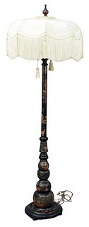 Chinoiserie Black Lacquered Floor Lamp, having figural and pagoda motif with a tassel shade, height 74 inches.