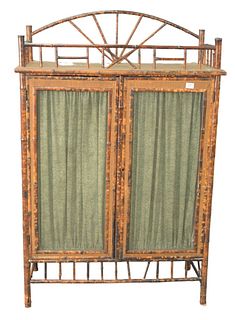 Bamboo Two Door Cabinet, having high gallery over two mesh doors opening to three interior shelves, height 60 inches, width 40 inches.
