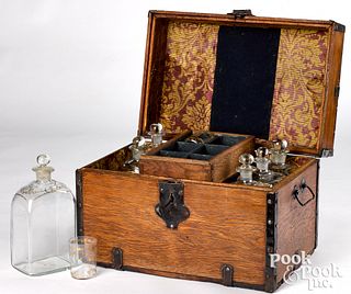 Oak bottle case, 19th c., fitted with gilt bottles