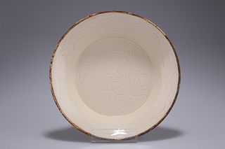 A CHINESE DING WARE DISH, circular with everted broad edge,