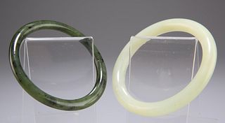 A CHINESE NEPHRITE JADE BANGLE, 7.7cm diameter; together wi
