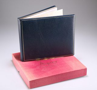 A BLUE AND TOOLED LEATHER BOUND VISITOR BOOK, with gilt edg