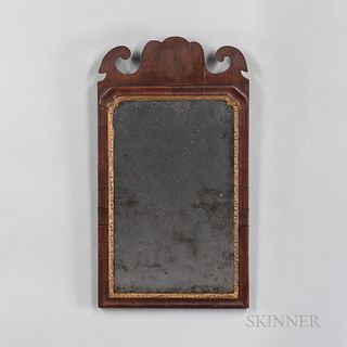 Queen Anne Walnut Veneer Mirror, 18th century, scrolling crest on a molded frame with a carved and gold-painted liner, ht. 21 3/4, wd.