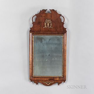 Baroque Walnut Veneer and Gilt Mirror, 18th century, the pierced and shaped crest with applied device, molded mirror frame with gilt li