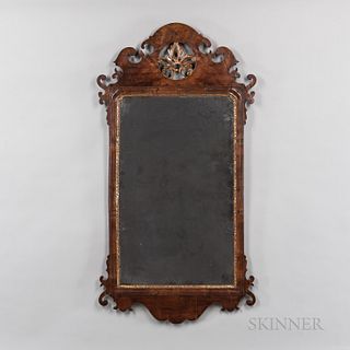 Large Walnut Veneer Scroll-frame Mirror, probably England, late 18th century, the crest centering pierced gilt-gesso leafage within an