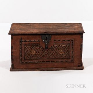 Carved Walnut Box, 18th century, the molded lift top above a dovetail-constructed well with till, and facade with geometric and floral-