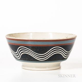 London-form Slip-decorated Pearlware Bowl, England, early 19th century, the bowl with lines of wavy white slip on a black slip field be