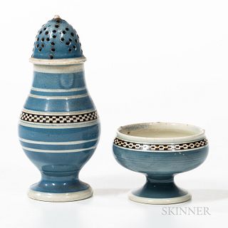 Checkered and Slip-decorated Pearlware Salt and Pepper Pot, England, early 19th century, the blue slip bodies with narrow checkered ban